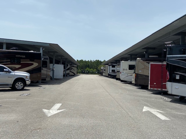 A lot of parked rvs in a parking lot.