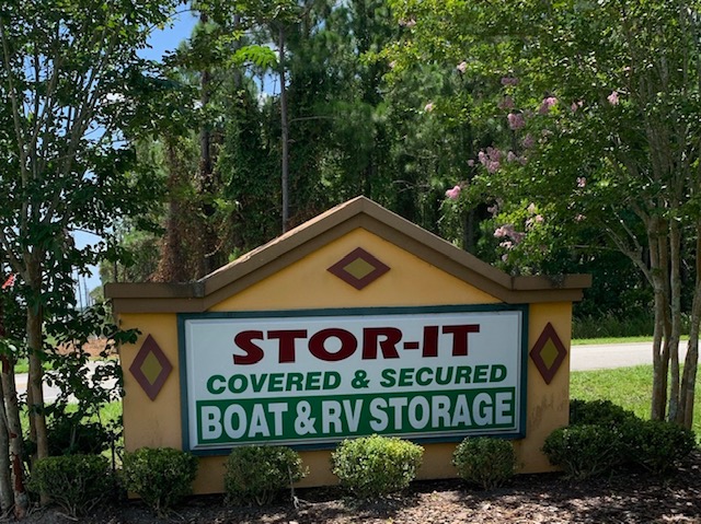 A sign for stor-it covered and secured boat & rv storage.